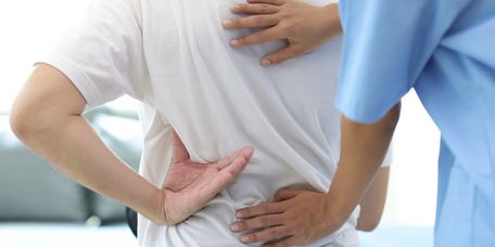 Arzt prüft den Rücken eines Patienten